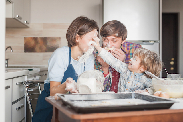 happy young family having fun with flour at kitche 9WULKXV